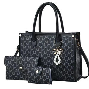 Black monogram tote bag set with pearl bow charm and matching wallet accessories