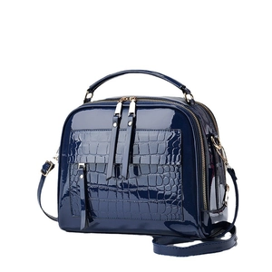 Navy blue patent leather crossbody bag with faux crocodile pocket and dual zippers