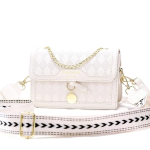 Chic beige quilted crossbody bag with stylish woven strap and gold chain handle