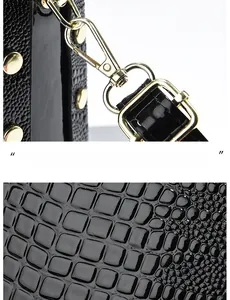 Detail of black crocodile texture patent leather bag with premium gold-plated hardware