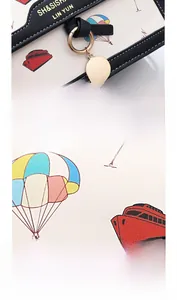Close-up of vibrant cartoon print on PU leather and polished gold metal charms for handbag