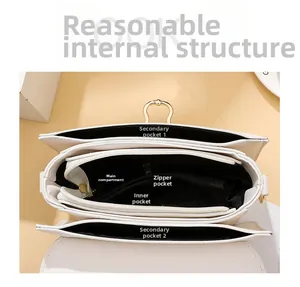 Detailed top view showing internal pockets and multi-compartment storage of white crossbody bag