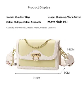 Detail of color-block crossbody bag with floral embroidered strap and gold hardware