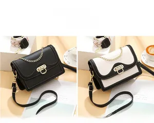 Detail view of contrast color crossbody bags with metal locks and chain decorations