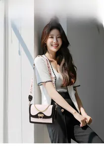 Detailed look at the rectangle flap crossbody bag with pink and black contrast and chain