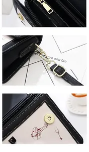 Close-up of golden metal zipper, spring hook and magnetic buckle on graffiti bag