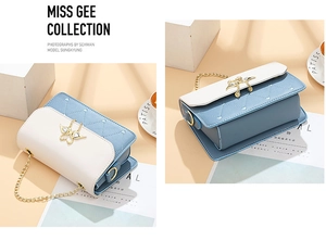 Detail of light blue crossbody bag featuring heart quilting and gold butterfly clasp