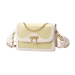Chic beige and yellow patchwork crossbody bag with stylish gold hardware and wide strap