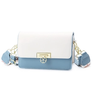 Blue and white color-block crossbody bag with gold clover buckle and floral strap