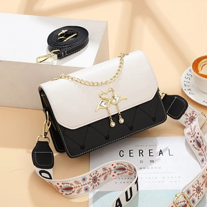 Chic black and white crossbody bag with quilted heart pattern and gold swan clasp