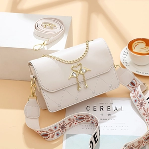 Chic quilted crossbody bag with heart texture, gold swan clasp and dual shoulder straps