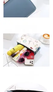 Detail view of multi-compartment mini crossbody bag showing storage for phone and umbrella