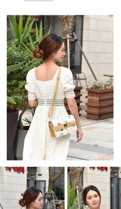 Detail showing white crossbody bag with balloon print and yellow strap on lace dress
