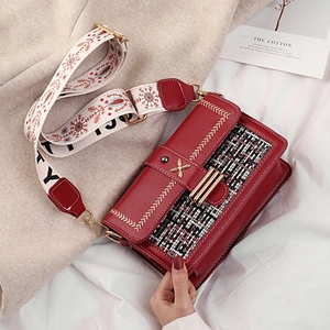 Red PU leather tote with tweed panel and embroidered strap in a stylish winter scene