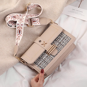 Chic beige crossbody bag with tweed panels and floral embroidery strap shown in front view