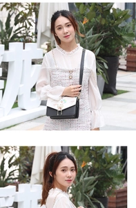 Outdoor street shot of a black and white crossbody bag with cartoon balloon prints