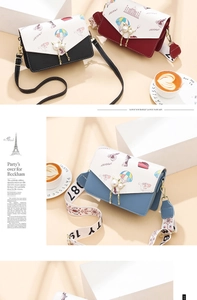 Detail of crossbody bag with travel patterns, pearl tassel buckle, and wide fabric strap