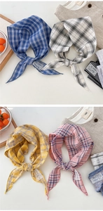 Detailed view of plaid cotton linen neck scarves with vintage labels in four colors
