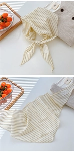 Close-up of lightweight plaid cotton linen neck scarf with thin stripes and lace patch