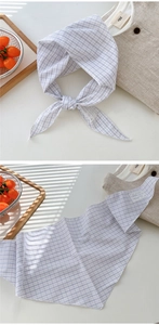 Detail of plaid cotton linen triangle scarf featuring a delicate blue and black grid pattern