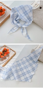 Detailed view of light blue checkered cotton linen triangle scarf with fine edge stitching