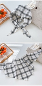 Detailed view of plaid cotton linen scarf with small lace label and check pattern