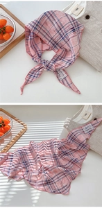 Detailed view of pink and blue checkered cotton linen scarf with distressed texture edges