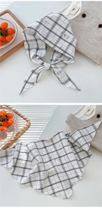 Detail view of plaid cotton linen scarf featuring frayed edges and vintage lace labels