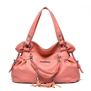 Salmon pink litchi grain leather tote bag with braided handles and tassel details
