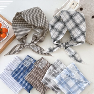 Assorted plaid cotton linen triangle bandanas for women in a lifestyle flat lay