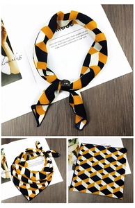 Detail of silk square scarf with 3D geometric patterns and black leather buckle