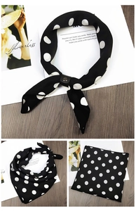 Polka dot silk scarf with leather buckle shown in folded and knotted styles on a wooden desk