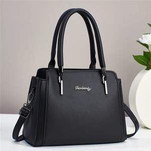 Detail of silver Danbaoly logo and textured leather on a black versatile handbag