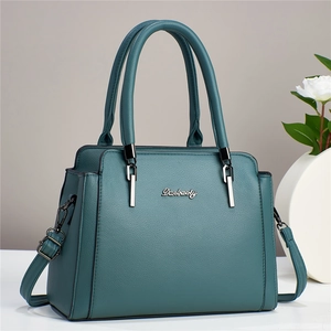 Deep green lychee leather tote bag with round handles and a detachable shoulder strap