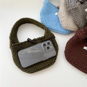 Detail of knit mini tote bags in multiple colors with vintage wooden button closures