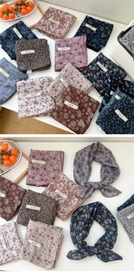 Macro shot of assorted floral cotton linen scarves with explore infinity branding labels