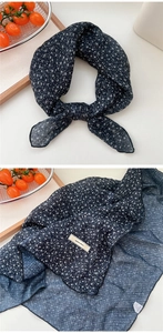 Detail of navy blue floral cotton linen scarf with fine stitched edges and fabric label