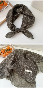 Macro detail of dark green floral cotton linen scarf featuring explore infinity label