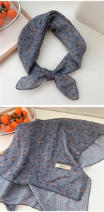 Detail of gray floral cotton linen scarf with tiny pink flowers and brand label