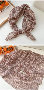 Detail of floral and houndstooth pattern cotton linen scarf with elegant stitched edge