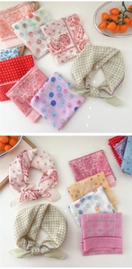 Flat lay of cotton linen polka dot and paisley neck scarves with various patterns