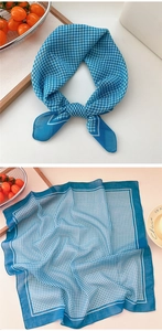 Detailed view of blue and white gingham cotton scarf with bold white border edges