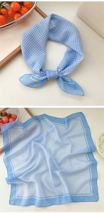Detail of blue and white checkered cotton linen scarf styled as a neckerchief and flat lay