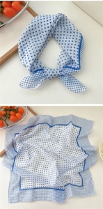 Detail of blue and white polka dot cotton linen square scarf showing fabric texture