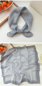 Detailed view of grey and white gingham cotton linen square scarf in flat and knotted styles