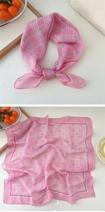 Close-up of pink and white checkered cotton linen scarf with soft fabric texture