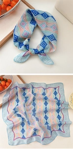 Detail of light blue geometric cotton linen scarf with pastel diamond pattern and tie detail
