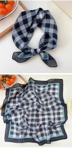 Detail of blue and white checkered cotton linen scarf with soft texture and refined edges
