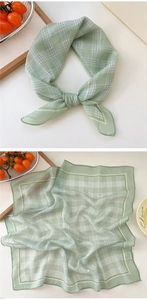 Detail of light green polka dot cotton linen square scarf with fine rolled edges and tag