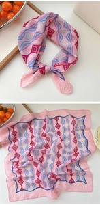 Detail of colorful geometric print silk scarf with stylish blue scalloped wave edges